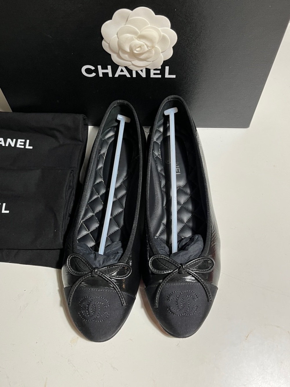 CHANEL Black Quilted Leather Ballet Flats with Logo Cap and Bow